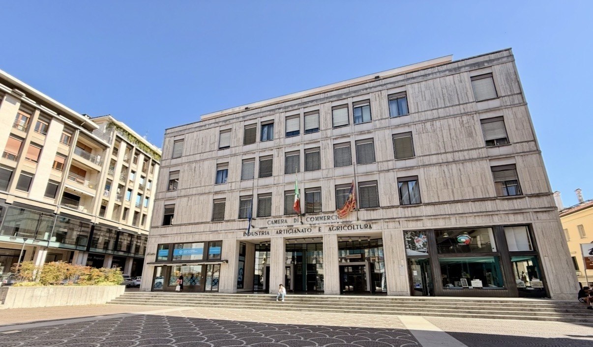 0-foto-si staglia in un cielo azzurro senza nuvole, la-Sede-a Treviso-Camera-di-Commercio un palazzo grande in una grande piazza attorniato da palazzi sempre dello periodo post ricostruzione bellica